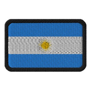 May include: A blue and white embroidered patch with a yellow sun in the center, representing the flag of Argentina.