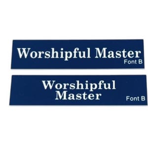 May include: Two rectangular navy blue plaques with white text that reads "Worshipful Master" and "Font B". The plaques are displayed against a white background. The text is centered on each plaque.