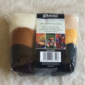 May include: A package of Corriedale wool sliver in white, brown, yellow, and black colors. The package is labeled "Ashford Wheels & Looms Corriedale Sliver 100% Pure New Zealand Wool 30 micron Corriedale wool. Perfect for all your fibre crafts. Needle felting, wet felting, spinning, weaving and knitting. Furry Friends 100gm NET"