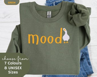 May include: A green sweatshirt with the word "mood" in yellow lettering and a white goose illustration. The sweatshirt is available in 7 colours and 8 sizes.
