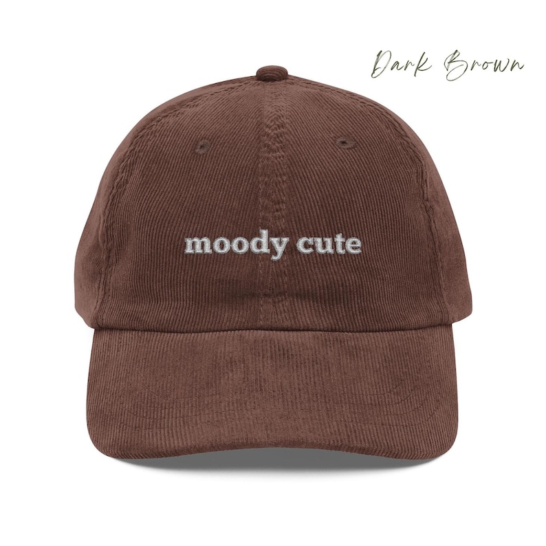 Dark Brown Corduroy Dad Cap with moody cute embroidered in light grey lettering. Unisex style adjustable sizing.