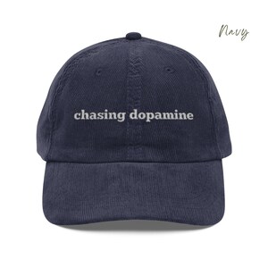 Vintage Corduroy dad hat in navy with embroidered text “chasing dopamine” in light grey thread . A minimalist, mental health inspired design.