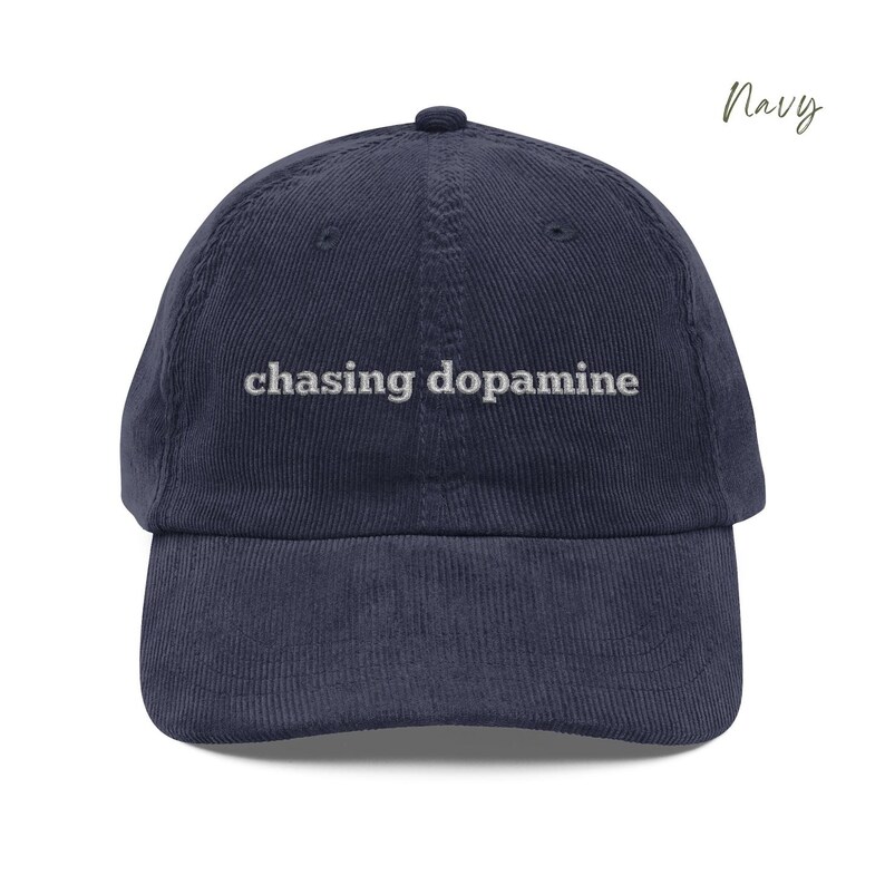 Vintage Corduroy dad hat in navy with embroidered text “chasing dopamine” in light grey thread . A minimalist, mental health inspired design.
