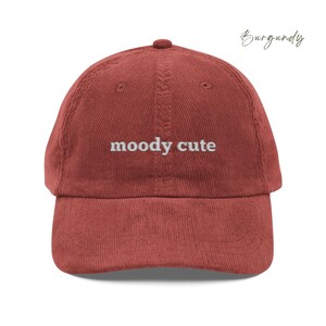 Burgundy Corduroy Dad Cap with moody cute embroidered in light grey lettering. Unisex style adjustable sizing.