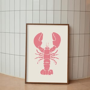 Op de afbeelding: Een ingelijst afdruk van een roze kreeft silhouet op een witte achtergrond.