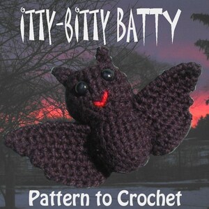 May include: A crocheted bat with a smiling face and large black eyes. The bat is a dark purple color and is set against a blurry background of trees and a sunset sky. The text "itty-bitty batty" is at the top of the image and the text "Pattern to Crochet" is at the bottom of the image.