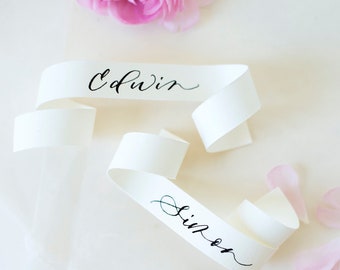 minimalist ribbon-like place cards with modern calligraphy | glam wedding detail, escort cards