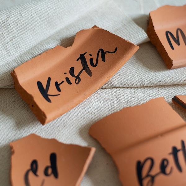 modern brushed calligraphy on broken terracotta | name card - place cards - boho wedding - desert themed - terra cotta shards - black ink