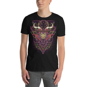 May include: Black t-shirt with a graphic design of a woman with horns and a moth. The design is in a geometric pattern with a pink, purple, and gold color scheme. The text "T-SHIRT" is included in the design.