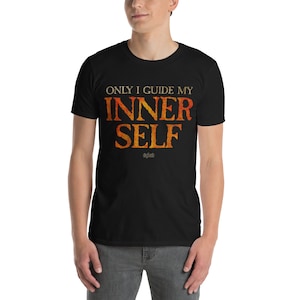 May include: Black t-shirt with the text "ONLY I GUIDE MY INNER SELF" in a gradient orange and yellow font. The shirt also has the word "sigilist" in a smaller font below the main text.