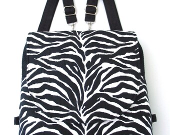 May include: Black and white zebra print backpack with adjustable black straps.