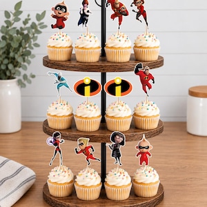 Op de afbeelding: Een houten cupcake-standaard met drie niveaus en twaalf cupcakes, voorzien van witte glazuur en kleurrijke hagelslag. Elke cupcake heeft een papieren topper met personages en logo's uit The Incredibles, waaronder Mr. Incredible, Elastigirl, Violet, Dash, Jack-Jack, Edna Mode, Frozone en het oranje-gele logo.