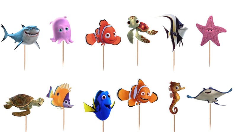 May include: A set of twelve decorative cupcake toppers featuring various colorful sea creatures including a shark, octopus, clownfish, sea turtle, angelfish, starfish, and stingray, each attached to a thin wooden pick for insertion into food items.
