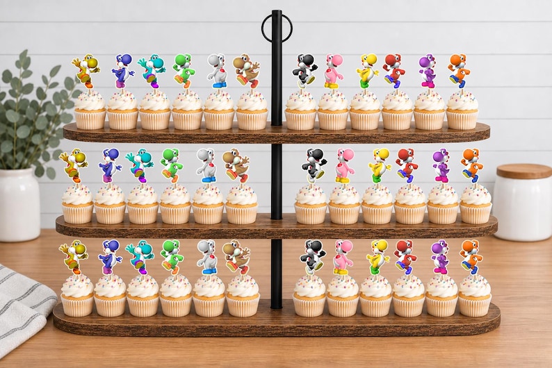 May include: A three-tiered wooden cupcake stand holding numerous cupcakes topped with colourful Yoshi character paper toppers. The toppers feature various Yoshi figures in yellow, blue, teal, green, white, brown, black, pink, and orange colours.
