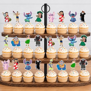 May include: A three-tiered wooden cupcake stand holding twenty-four cupcakes topped with colorful paper cutouts of characters from Lilo and Stitch. Each cupcake features a different character, including Stitch, Lilo, and various aliens on sticks.
