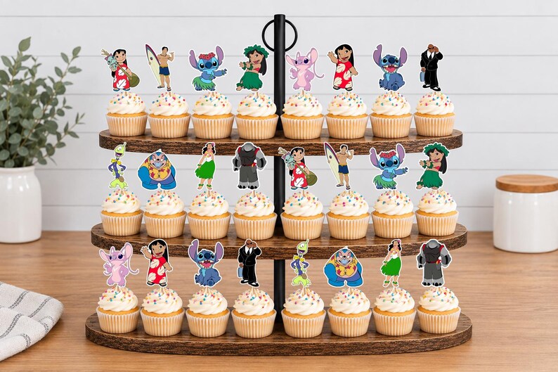 May include: A three-tiered wooden cupcake stand holding twenty-four cupcakes topped with colorful paper cutouts of characters from Lilo and Stitch. Each cupcake features a different character, including Stitch, Lilo, and various aliens on sticks.