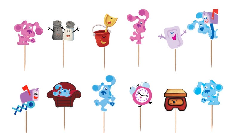 May include: A set of twelve decorative cupcake toppers featuring colorful cartoon characters and objects from Blue's Clues, including blue and magenta dogs, a red bucket, a mailbox, a pink alarm clock, a red armchair, and a soap bar on wooden picks.