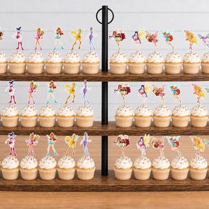 May include: A three-tiered wooden cupcake stand holding numerous cupcakes topped with colorful fairy-themed paper toppers. Each cupcake features a small, distinct character illustration on a pick, arranged in rows across the dark wood shelves.