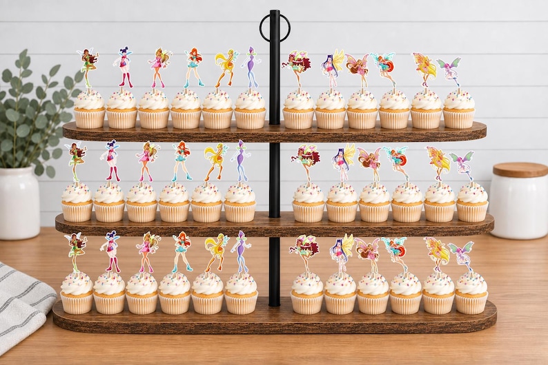 May include: A three-tiered wooden cupcake stand holding numerous cupcakes topped with colorful fairy-themed paper toppers. Each cupcake features a small, distinct character illustration on a pick, arranged in rows across the dark wood shelves.