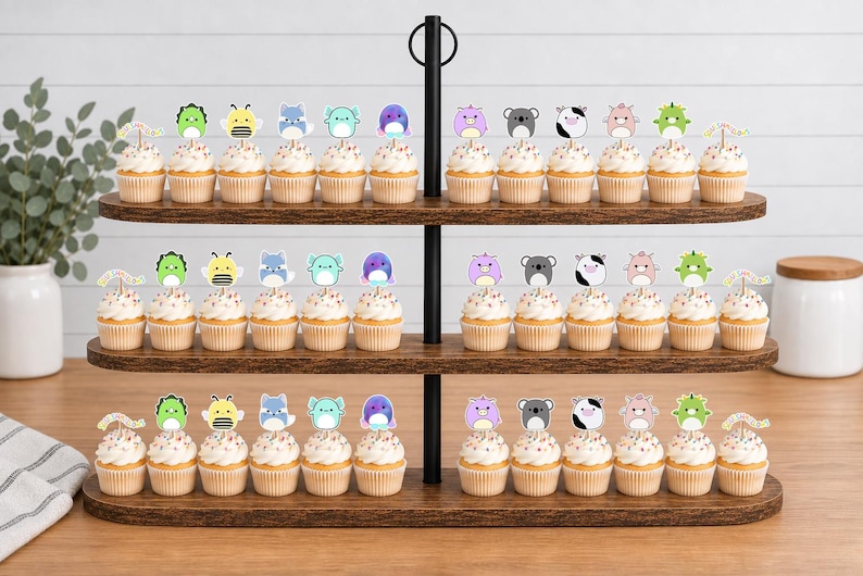 May include: A three-tiered wooden cupcake stand holding rows of cupcakes topped with colorful animal-shaped paper toppers. The toppers feature various creatures including bees, koalas, cows, and dragons, each attached to a small wooden pick.