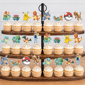 May include: A three-tiered wooden cupcake stand holding twenty-four cupcakes topped with colorful paper cutouts of various animated creatures and a red and white ball. Each cupcake features a different character design on a stick inserted into the frosting.