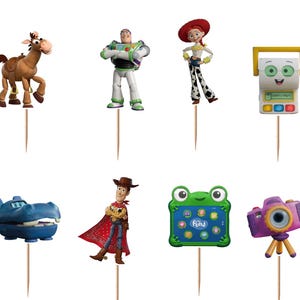 May include: A set of twelve decorative cupcake toppers featuring various animated characters and objects, including a white spork, a brown horse, a space ranger, a cowgirl, a yellow and white device, a black and white pig, a blue hippo, a cowboy, a green frog tablet, and a purple camera.