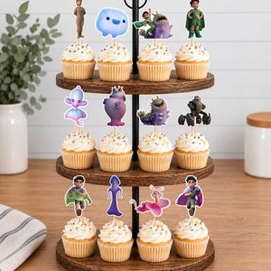 May include: A three-tiered wooden cupcake stand holding twelve cupcakes, each topped with a unique character cutout. The cupcakes feature white frosting with colourful sprinkles, and the character toppers depict various animated figures in diverse poses.