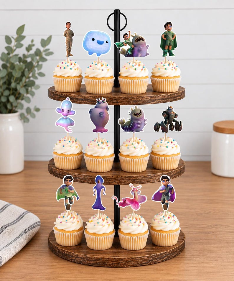 May include: A three-tiered wooden cupcake stand holding twelve cupcakes, each topped with a unique character cutout. The cupcakes feature white frosting with colourful sprinkles, and the character toppers depict various animated figures in diverse poses.