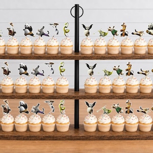 May include: A three-tiered wooden cupcake stand holding numerous cupcakes topped with Kung Fu Panda character paper toppers. The stand features a black metal central handle and horizontal wooden shelves, displaying various animated character figures.