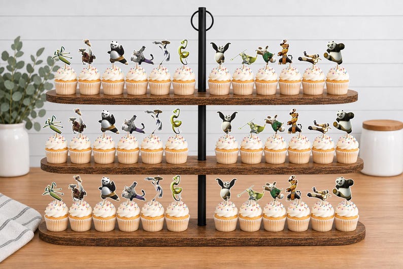 May include: A three-tiered wooden cupcake stand holding numerous cupcakes topped with Kung Fu Panda character paper toppers. The stand features a black metal central handle and horizontal wooden shelves, displaying various animated character figures.