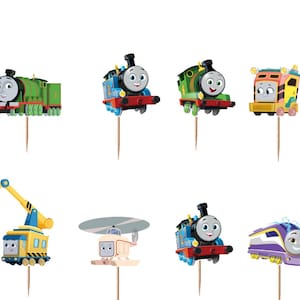 May include: A set of twelve decorative cupcake toppers featuring various colorful cartoon trains and vehicles from the Thomas and Friends series, each attached to a thin wooden pick for insertion into food items.