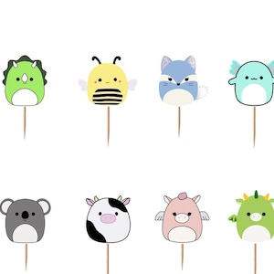 May include: A set of twelve decorative cupcake toppers featuring various cartoon animal characters and two signs with the text Squishmallows. Each topper consists of a colorful character head or sign attached to a thin, light brown wooden pick.