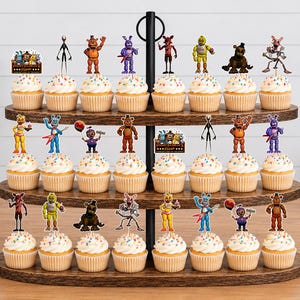 May include: A three-tiered wooden cupcake stand holding twenty-four cupcakes topped with colourful sprinkles and various Five Nights at Freddy's character paper toppers. The toppers feature figures like Freddy, Bonnie, Chica, and Foxy.