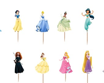 May include: A set of twelve decorative cupcake toppers featuring various animated female characters in colorful gowns and outfits, each attached to a thin wooden toothpick. The characters include figures in blue, yellow, green, teal, and pink dresses.