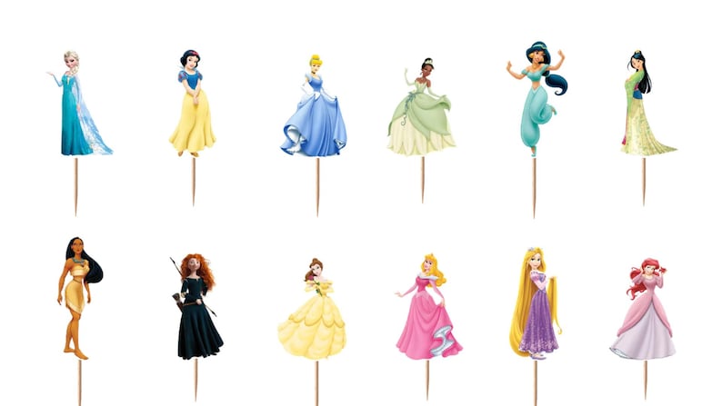 May include: A set of twelve decorative cupcake toppers featuring various animated female characters in colorful gowns and outfits, each attached to a thin wooden toothpick. The characters include figures in blue, yellow, green, teal, and pink dresses.