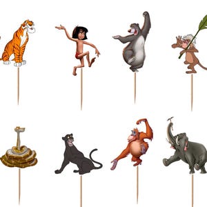 May include: A set of twelve decorative cupcake toppers featuring various animated characters from The Jungle Book, including a boy, a tiger, a bear, a panther, a snake, an orangutan, an elephant, and vultures, each attached to a wooden pick.