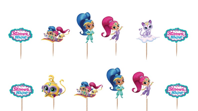 May include: A set of decorative cupcake toppers featuring Shimmer and Shine characters, including genies with blue and pink hair, a purple cat, and a yellow monkey, all attached to wooden picks with teal-bordered Shimmer and Shine logo signs.