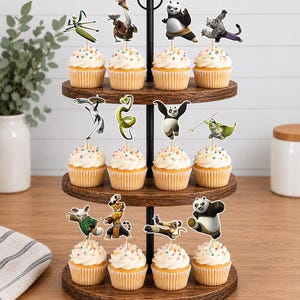 May include: A three-tiered wooden cupcake stand holding twelve cupcakes, each topped with a paper cutout of a Kung Fu Panda character. The cupcakes feature white frosting with colorful sprinkles, arranged on dark brown circular wooden trays.
