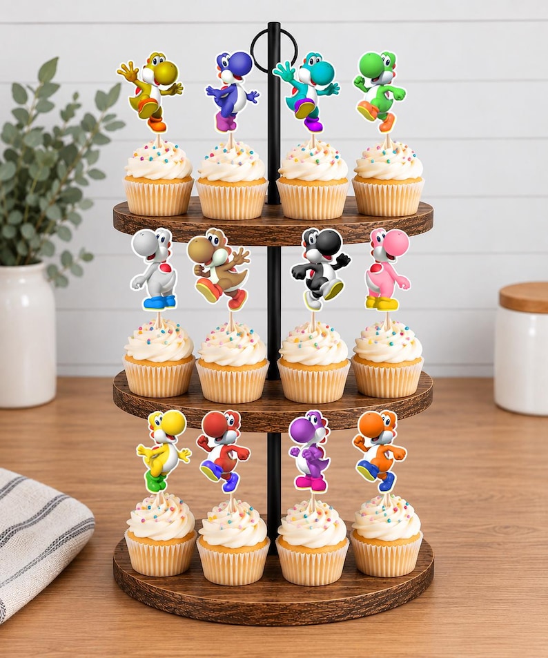 May include: A three-tiered wooden cupcake stand holding twelve cupcakes, each topped with a colourful Yoshi character cutout. The cupcakes feature white frosting with multi-coloured sprinkles, and the Yoshi figures appear in yellow, blue, teal, green, white, brown, black, pink, red, purple, and orange.