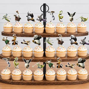 May include: A three-tiered wooden cupcake stand holding twenty-four cupcakes, each topped with a paper cutout of characters from the Kung Fu Panda film series, including Po, Tigress, Shifu, Mantis, Viper, Monkey, and Crane on white frosting.