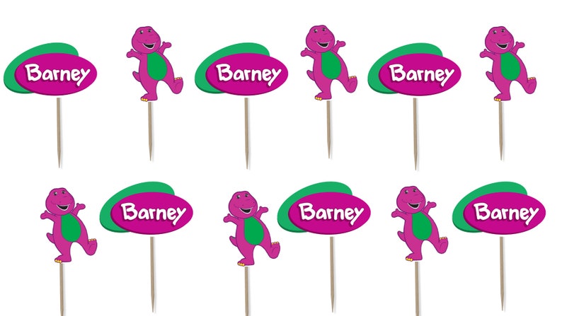 May include: A collection of ten cupcake toppers featuring the character Barney. Each topper has a purple Barney figure with a green belly and a green and purple oval with the name "Barney". The toppers are attached to wooden sticks.