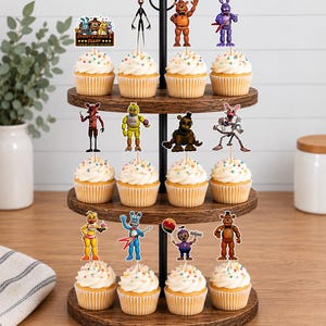May include: A three-tiered wooden cupcake stand holding twelve cupcakes topped with colourful sprinkles and Five Nights at Freddy's character toppers. The top tier features a sign reading Freddy Fazbear's Pizza Come Be A Part Of The Show.