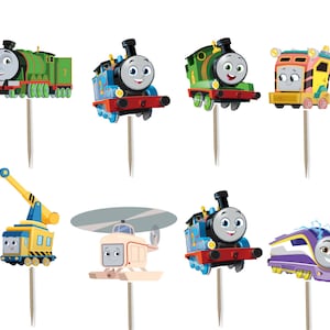 May include: A collection of colorful train-themed cupcake toppers featuring various characters. The toppers include trains in red, blue, green, and yellow, each with a smiling face. They are attached to wooden sticks for easy insertion into cupcakes.