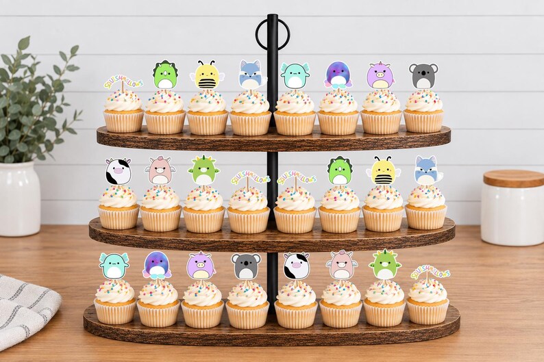 May include: A three-tiered wooden cupcake stand holding twenty-four cupcakes topped with white frosting, colorful sprinkles, and various animal-themed paper toppers. Each topper features a cartoon character, including cows, bees, and koalas.