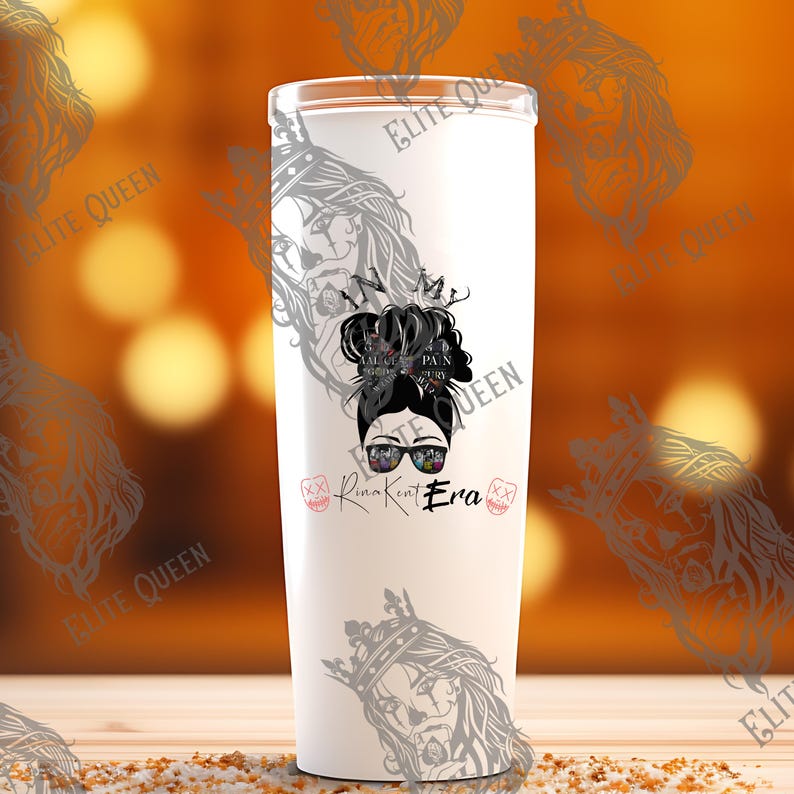 May include: A white tumbler with a black graphic of a woman with sunglasses and a messy bun. The text on the tumbler reads "Rina Kent Era" and "Pain, Glory, Victory". The tumbler has a silver lid.