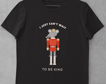 May include: Black t-shirt with a graphic of a mouse dressed as a toy soldier, wearing a crown. Text above the mouse reads "I JUST CAN'T WAIT", and below it says "TO BE KING".