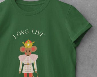 May include: Green t-shirt with the text "LONG LIVE THE QUEEN". The shirt features a cartoon mouse wearing a crown and a military-style uniform in white, pink, and red. The design is centered on the shirt.