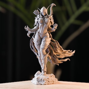 May include: A detailed, grey, 3D printed figurine of a female warrior with a bow and arrow, wearing a hooded cloak and armour. The figurine is standing on a rocky base.