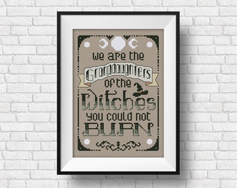 May include: A framed cross-stitch design with a beige background and black text that reads "We are the Granddaughters of the Witches you could not BURN". The design includes three moons and a witch's hat.