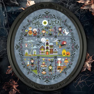 May include: A blue and black framed cross-stitch design featuring a Halloween scene with a haunted house, witches, ghosts, and bats. The text "HALLOWEEN" is stitched in white thread.